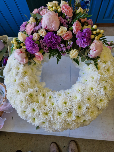Forever Cherished - A beautiful funeral wreath in soft pink, purple and white tones, created as a thoughtful and elegant tribute.