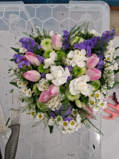 Spring Whispers - A pretty arrangement in soft pink, purple, white and green tones with a fresh seasonal feel.