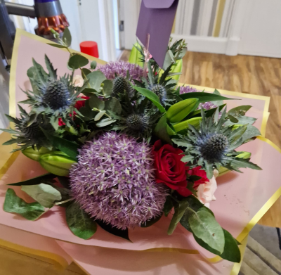 Wild Heather - A bold and contemporary hand-tied featuring rich purple, red and green tones with a natural, textured feel.