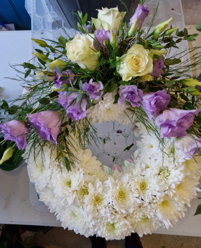 Gentle Memories - A classic funeral wreath in white and soft lilac tones, created with care to honour someone special.