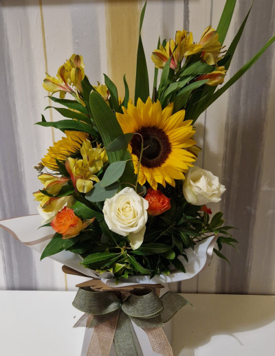Golden Glow - A bright and uplifting arrangement in warm golden, orange and cream tones, perfect for bringing a little sunshine to any occasion.